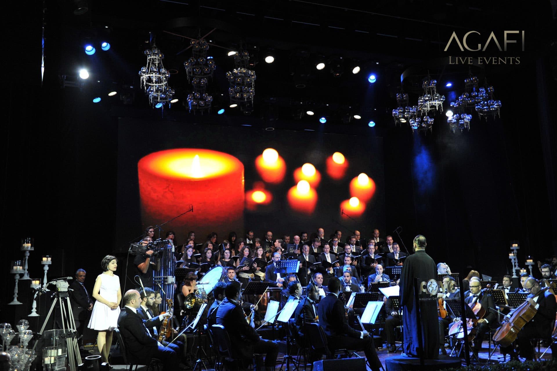 The choir and orchestra beneath a screen of candles