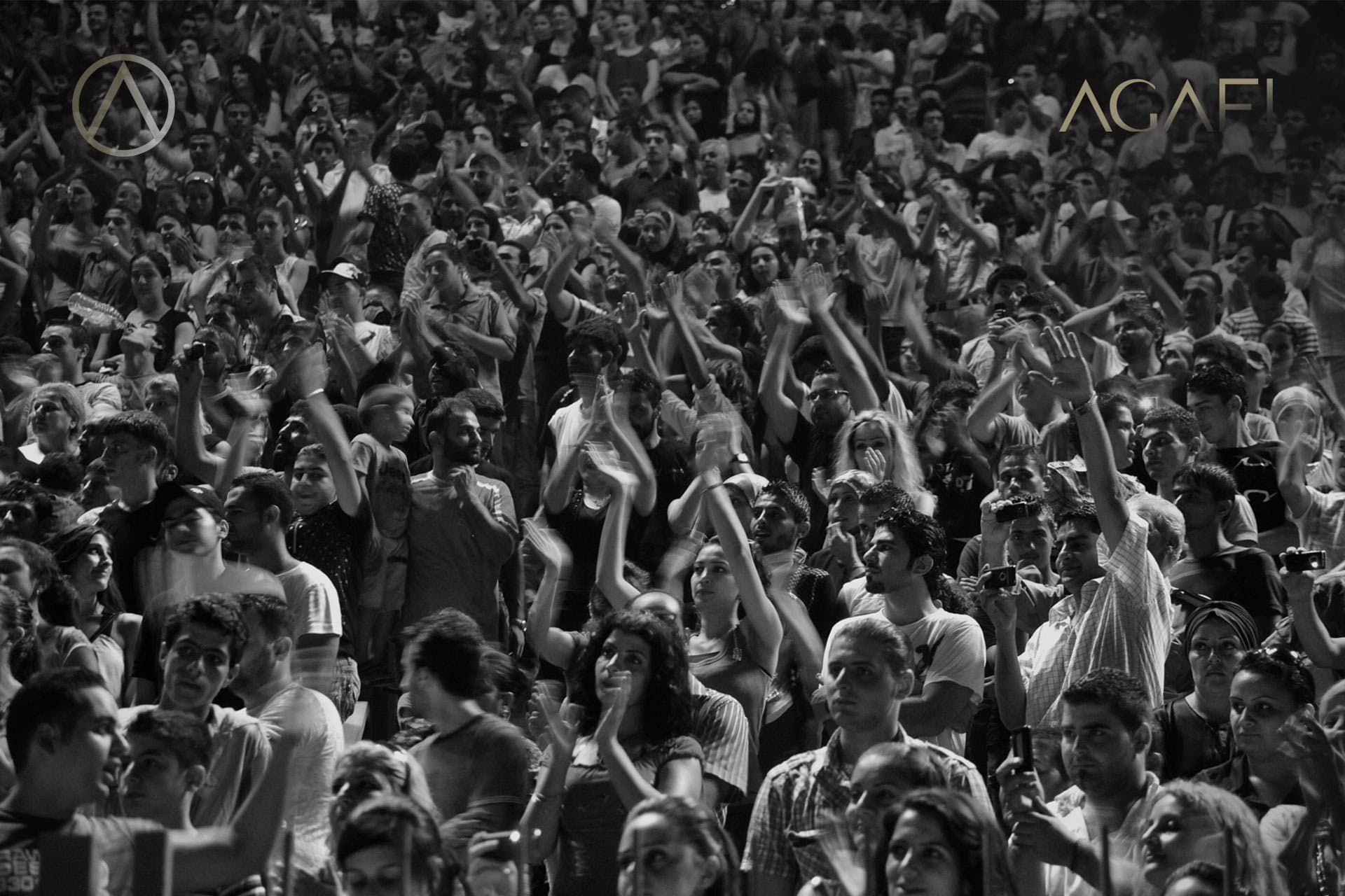 The crowd with hands raised