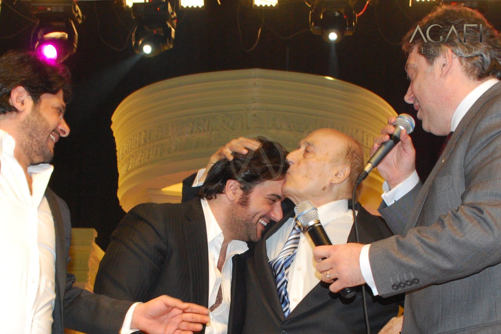 Wadee Al Safi kissed on the head by a singer on stage