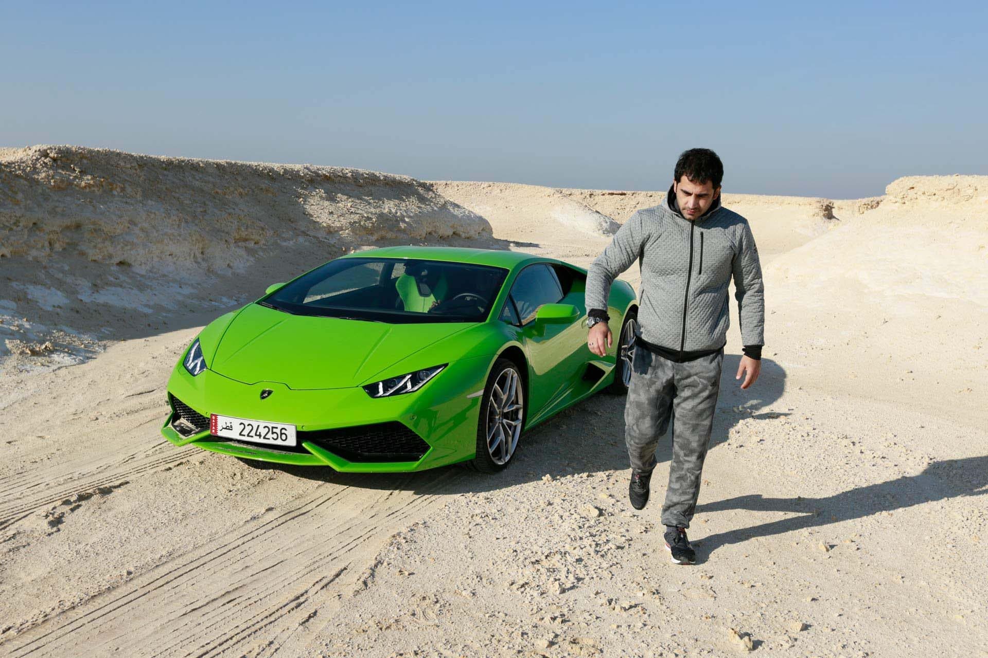 A driver walking away from the Lamborghini