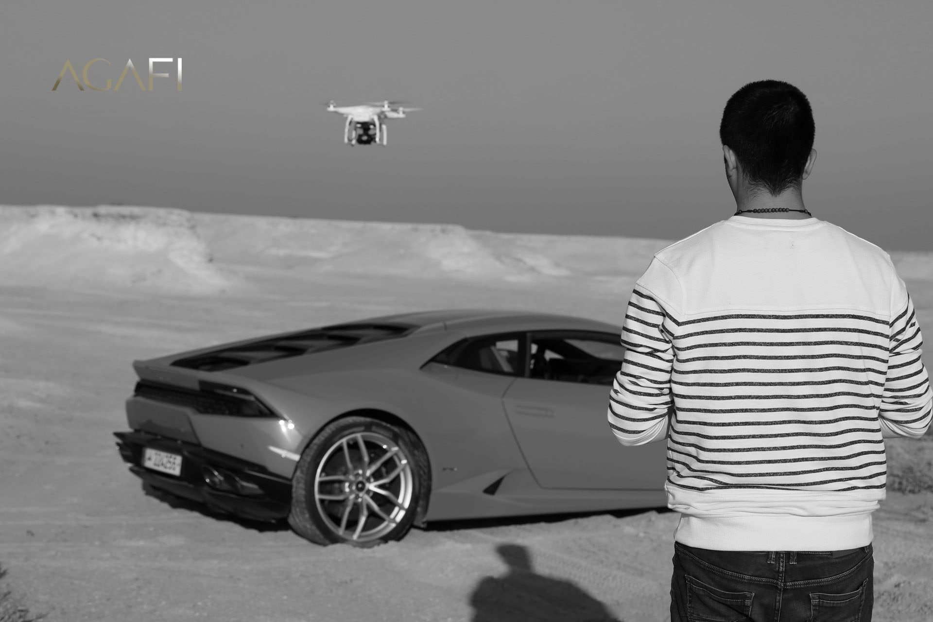 A drone filming the Lamborghini over the sand