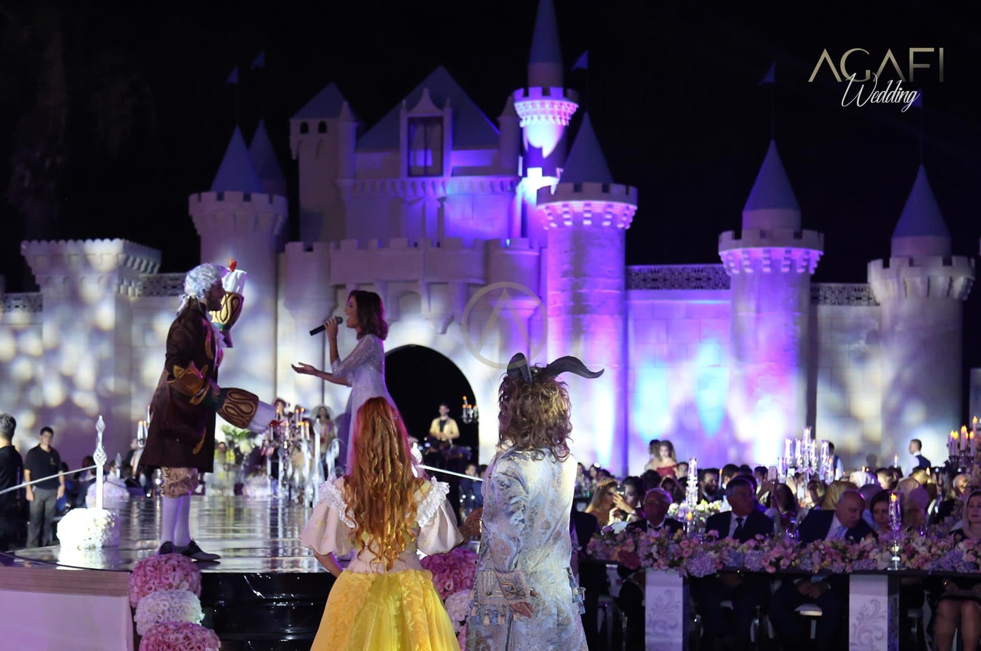 Characters performing in front of the castle in purple light