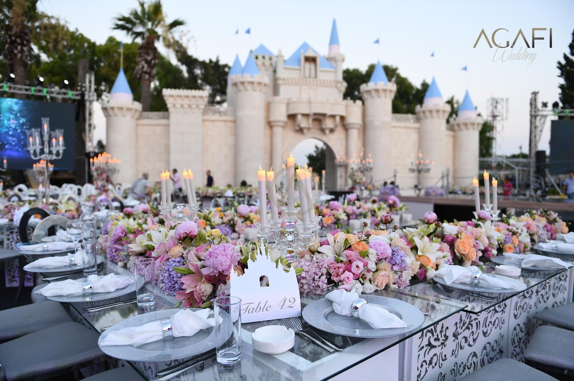 A table set with flowers before the castle by day