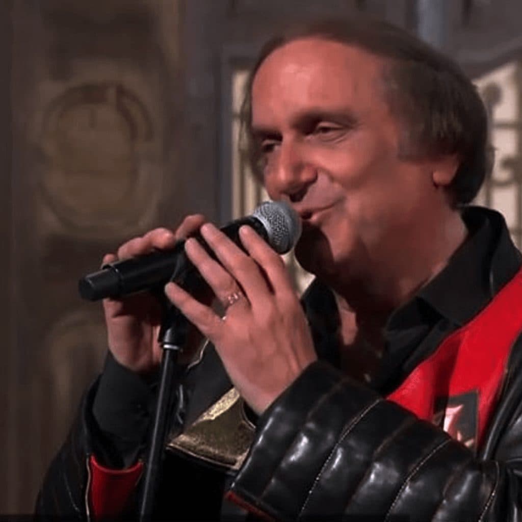 A singer with a microphone, in a leather jacket