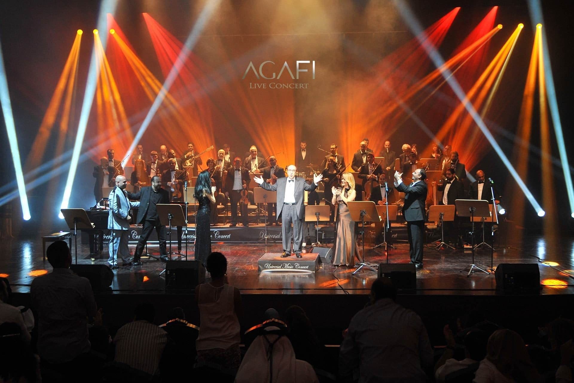 An orchestra and singers under orange and white beams