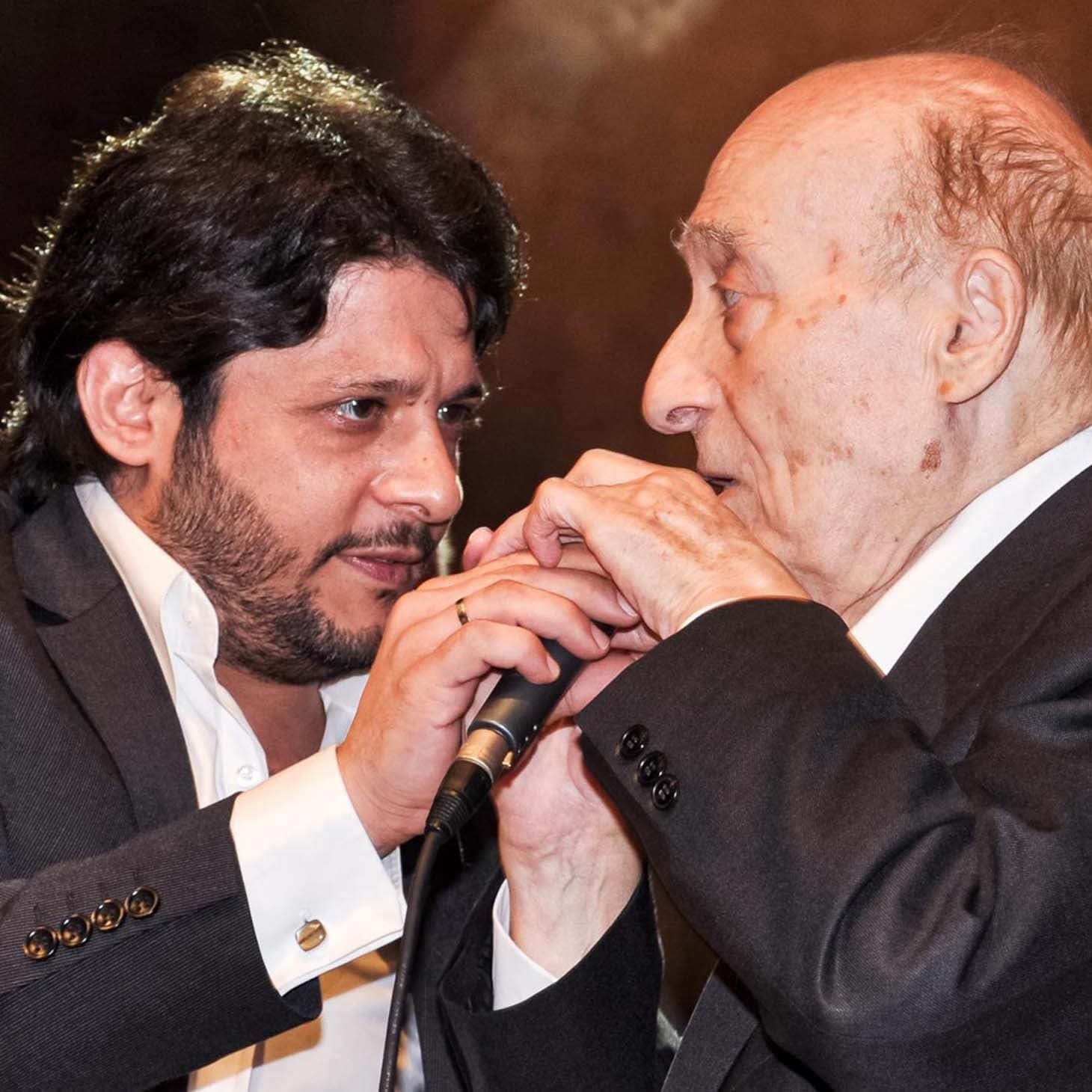Two singers sharing a microphone